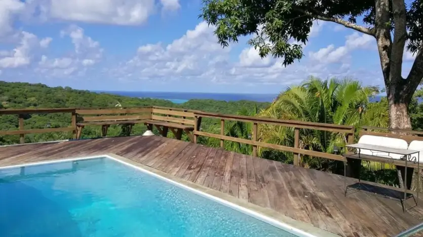 Pool deck with ocean view at a home in Big Bight, Roatan