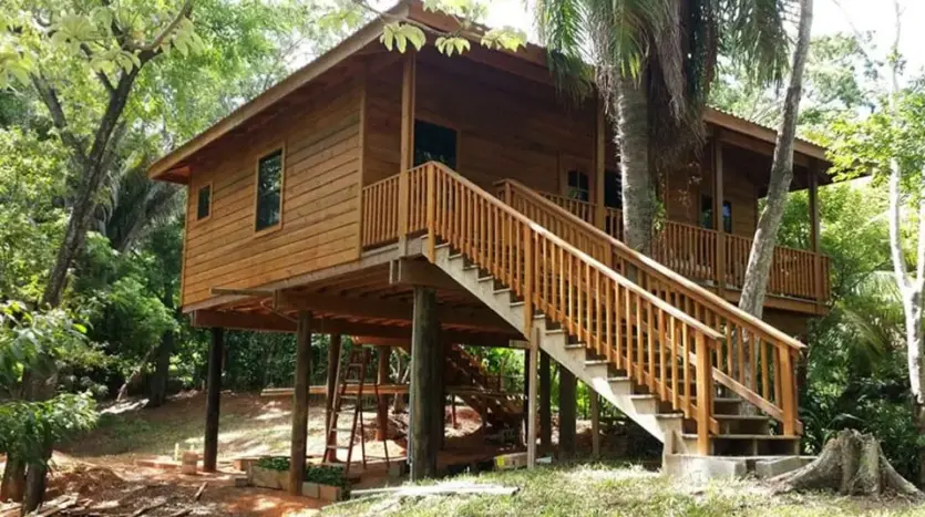 Two-story wooden house on stilts in West End, Roatan