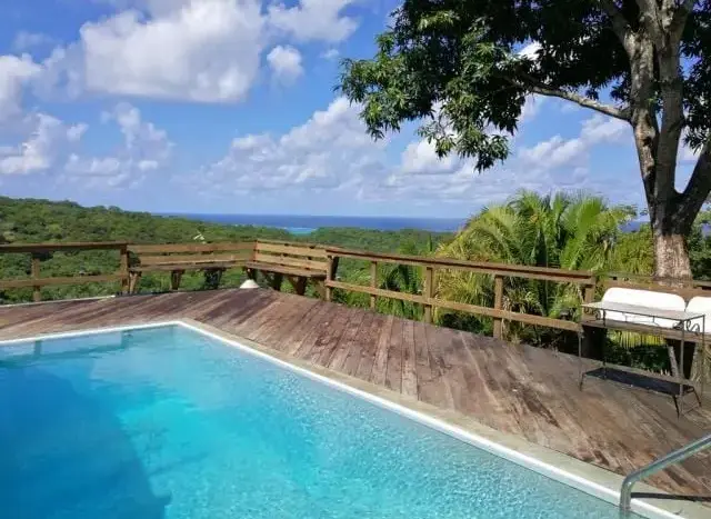 Pool deck with ocean view at the home in French Harbour, Roatan