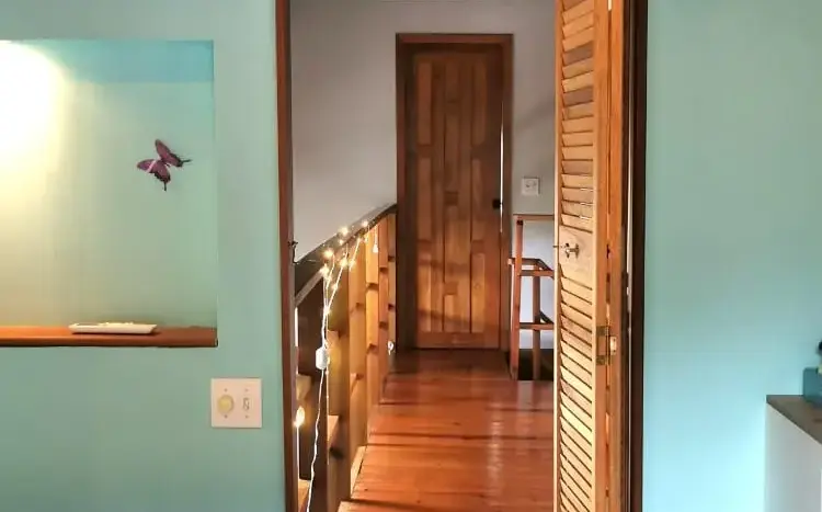 Bedroom doorway with wood floors at Flamingo House, Roatan
