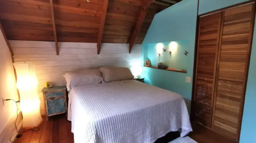 Bedroom with wood ceiling and closet at Flamingo House, Roatan