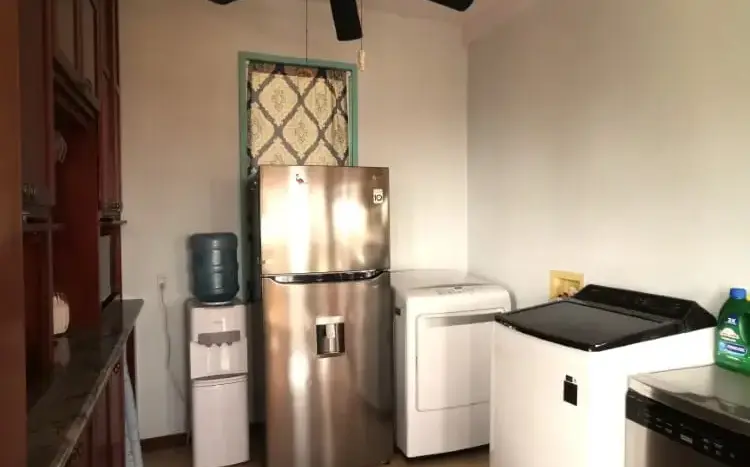Kitchen with stainless steel fridge at Flamingo House, First Bight, Roatan
