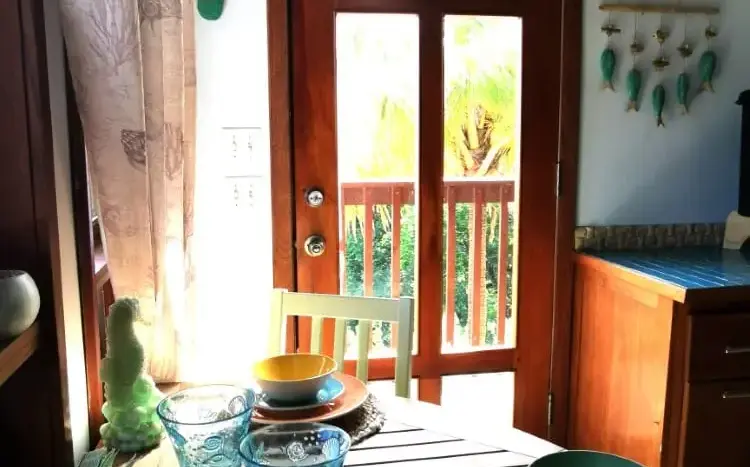 Dining table set by the balcony door at Flamingo House, Roatan
