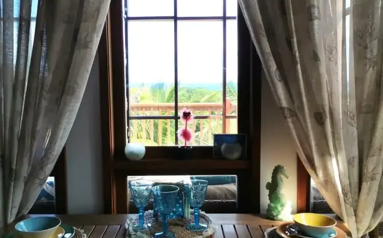 Round dining table with window view at Flamingo House, First Bight, Roatan