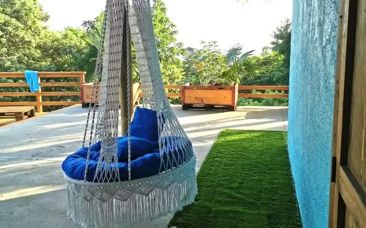 Covered terrace with hanging chair at Flamingo House, Roatan