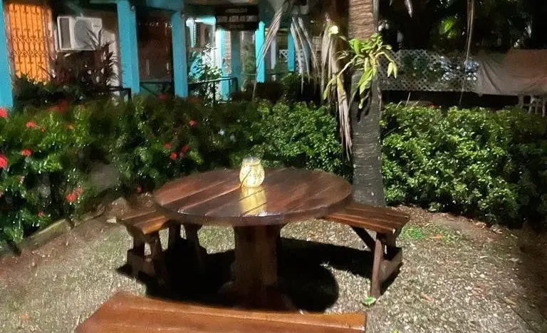 Garden table lit at night at the apartments in Puerto Cortes