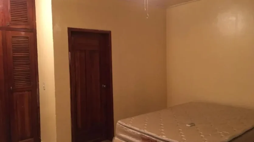 Bedroom with wooden doors in an apartment in Puerto Cortes