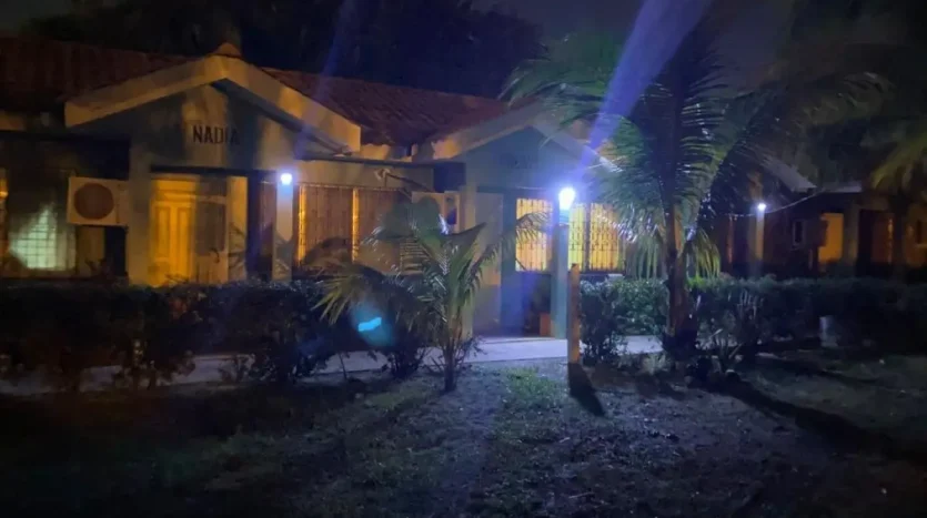 Apartments and palm trees at night in Puerto Cortes