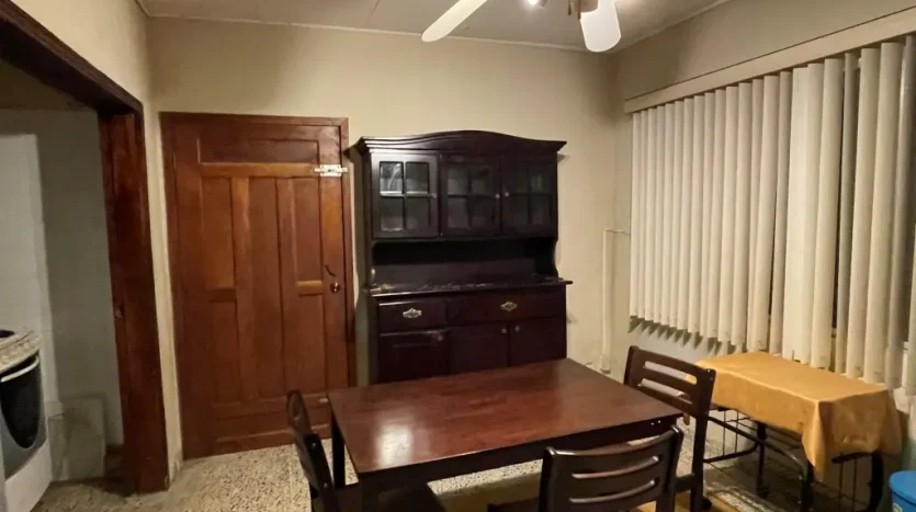 Dining area with wooden table in an apartment in Puerto Cortes