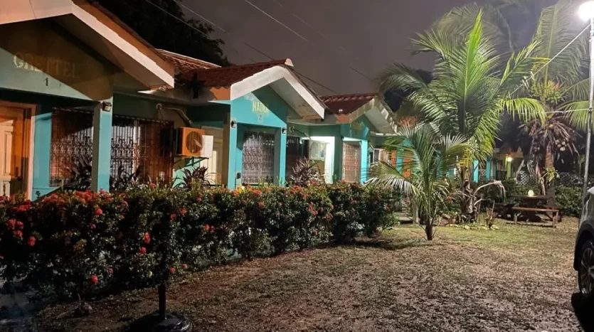 Row of turquoise apartments at night in Puerto Cortes