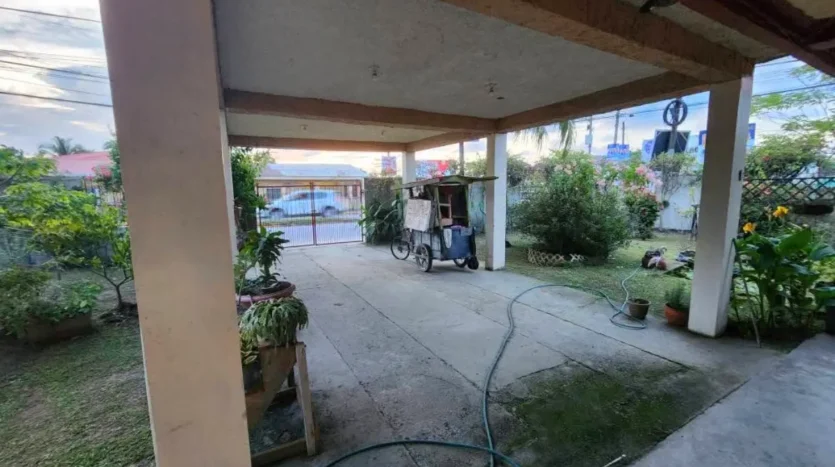 Covered carport of the corner home in Barrio Las Brisas, Tela