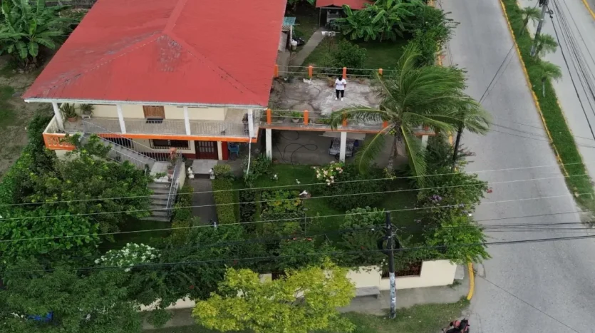 Aerial view of the corner home with red roof in Tela