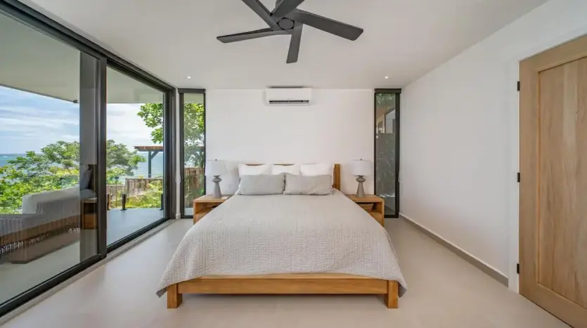 Bedroom opening to an ocean-view balcony