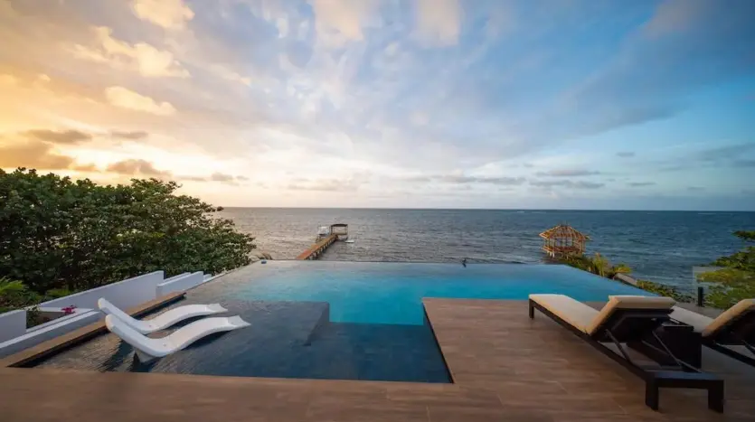 Sun loungers by the infinity pool facing the sea