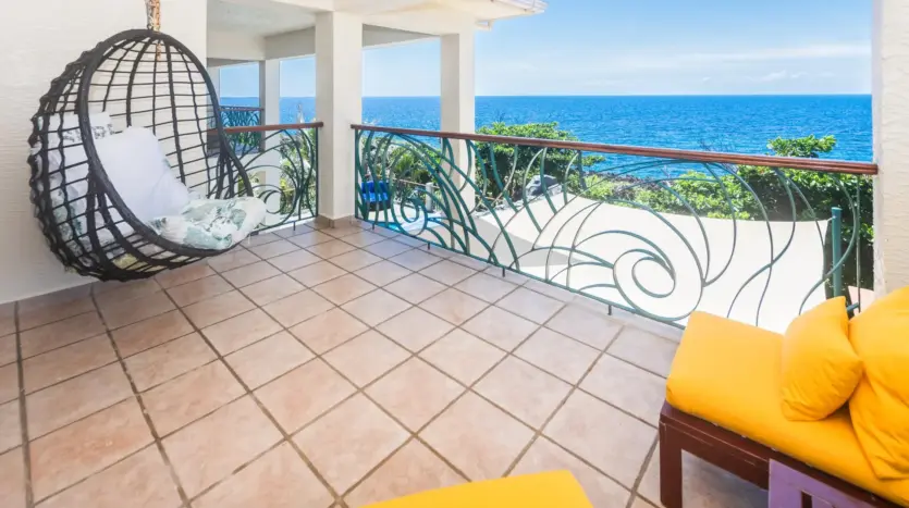 Balcony with hanging chair and sea view
