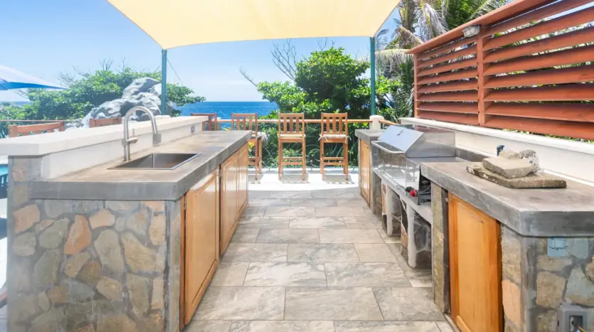 Outdoor kitchen and bar by the pool