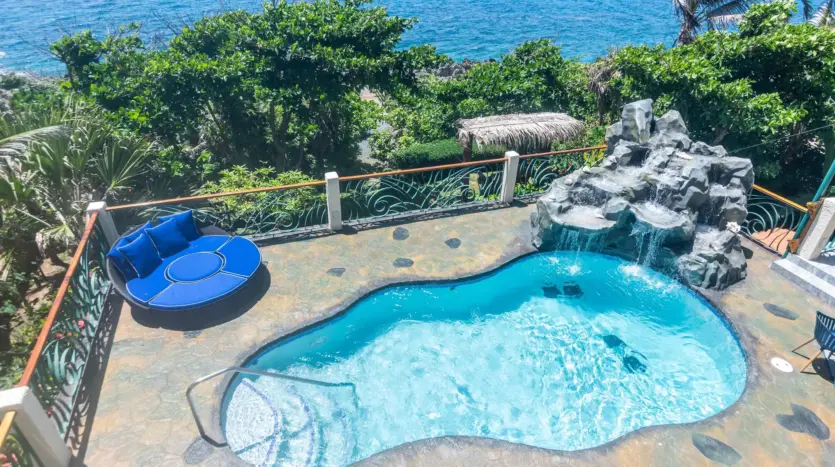 Pool and waterfall with sea view
