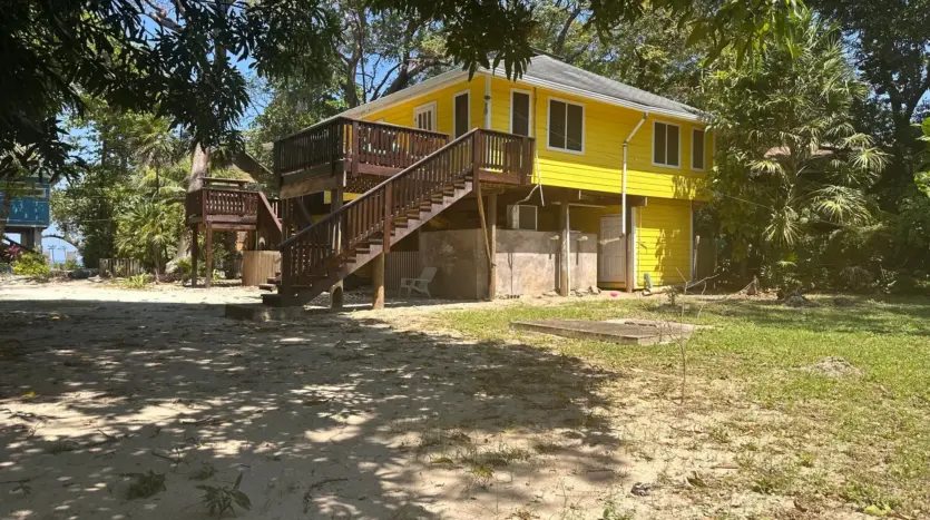 Side view of the cabana on its shaded sandy lot