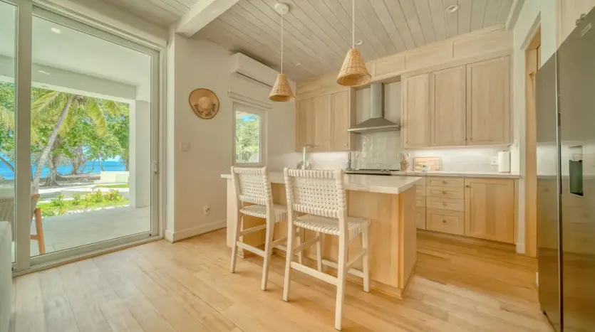 Kitchen with island and bar stools, sample unit