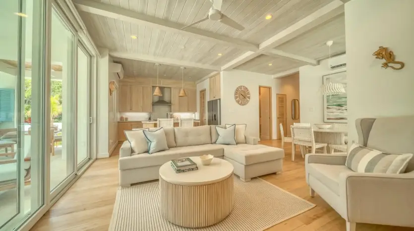 Living room with light wood floors, sample unit